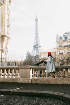 Young woman looking the Eiffel Tower from distance