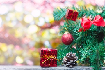 Close up of red gift box and pinecone on wooden table for Christmas or New Year decoration background