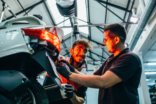 Mechanics working in the motorbike workshop