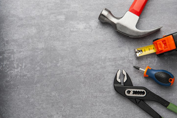 Set of tools on grey background.