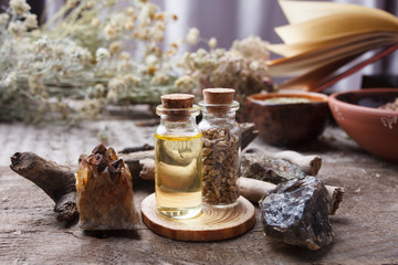 mystic still life with old book, amulets, stone, bottles. Witchcraft composition. Halloween and...