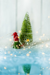 lovely Christmas and winter bright background with a conceptual, snowy landscape, golden lights and a green Christmas tree