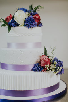 Colorful purple and white designer wedding cake