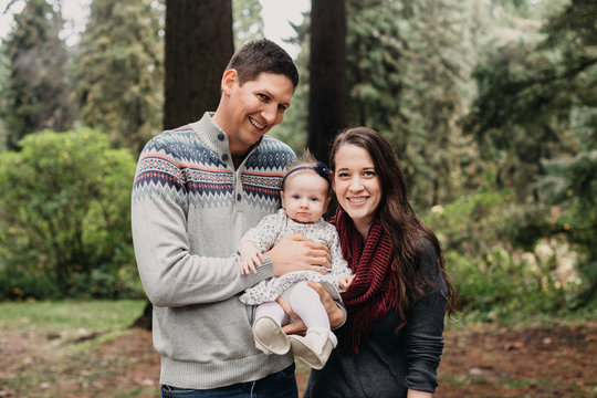 Young Family Holding Sweet Baby