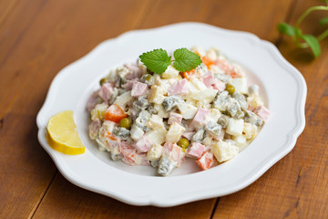 Traditional Russian salad on a wooden table