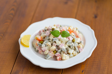 Traditional Russian salad on a wooden table
