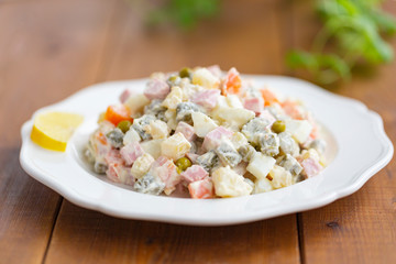 Traditional Russian salad on a wooden table