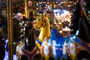 Carousel with rocking horses on christmas market in Moscow, Russia