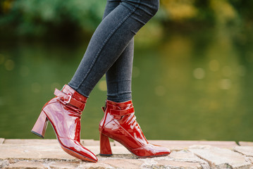 Female legs in brown leather boots outdoors