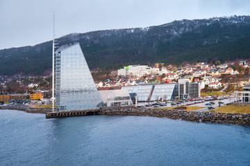 Norwegian City view to Molde from the sea side with fog at the background during winter