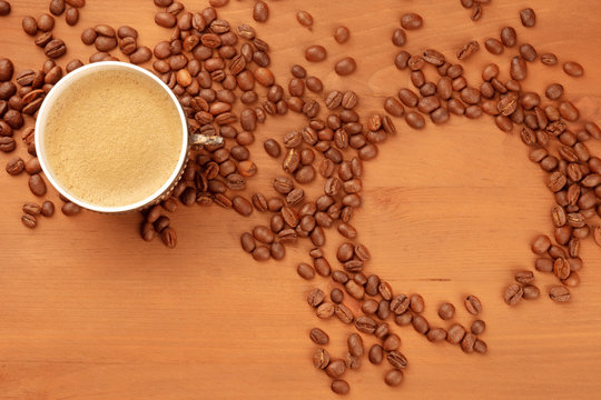 A photo of coffee in a vintage cup, shot from the top with coffee beans forming a frame, with a place for text, toned image