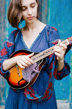 Young girl playing the ukulele