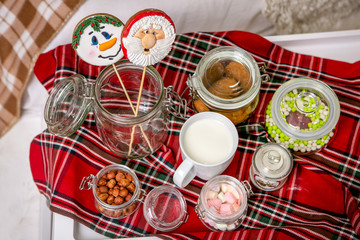 Gingerbread snowman and Santa on a stick on the breakfast table in the bedroom. Holiday sweets. New Year and Christmas theme. Festive mood