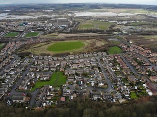 Aerial photo taken over Leeds showing houses, streets, paths and fields, taken in West Yorkshire