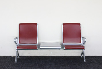 Empty chairs on carpet floor and white wall