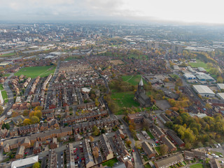 Aerial photo taken over Leeds showing houses, streets, paths and fields, taken in West Yorkshire