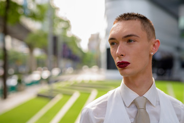 Obraz premium Young androgynous homosexual LGTB businessman wearing lipstick