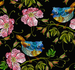 Embroidery wild roses and tropical birds seamless pattern. Template for clothes, textiles, t-shirt design. Beautiful birds and flowers of dogrose background