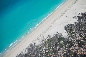 Aerial view of blue waters and sandy beach