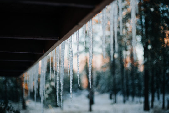 Icicles hanging from the eves of a porch roof.