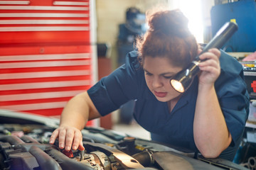 Female Mechanic Working on Cars in Her Shop