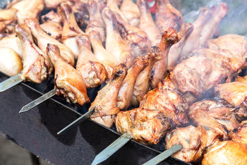 Appetizing shashlik from chicken meat on metal skewers