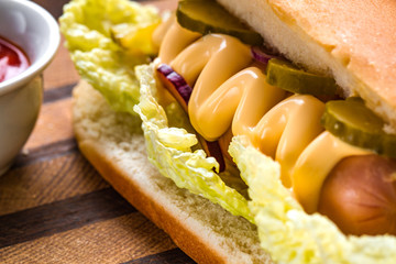 Tasty hot dog with yellow mustard close up