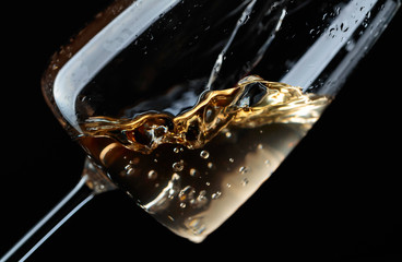 White wine being poured into wine glass.