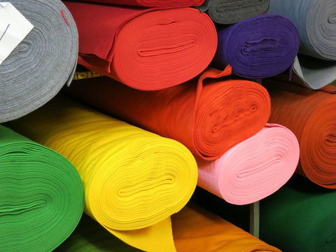 rolls of felt on a plank in different colors