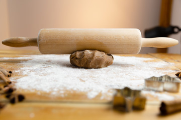 Preparation of Christmas gingerbread cookies on wooden background.