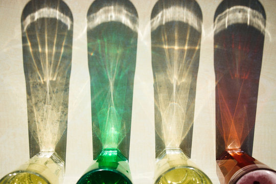 Shadow of colorful lemonade drinks on table