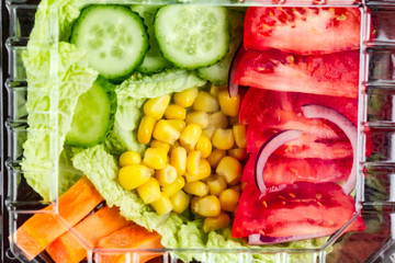 Dietary, healthy meal in a plastic container. Eat right concept. Snack at work, in the office at lunch time, during a break. Lunch box. Healthy food and nutrition concept
