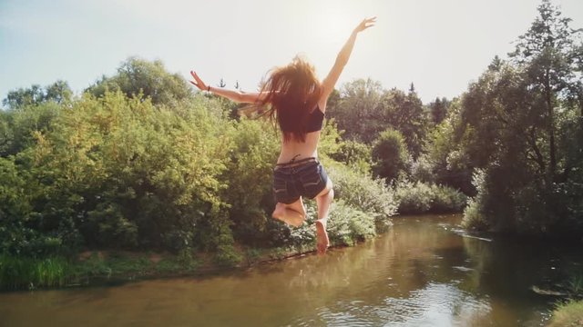Girl runs up and jumping into the water