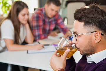 Young professional man drink tea have a break at business brainstorming