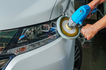 Car headlights with power buffer machine at service station - a series of CAR CARE images.