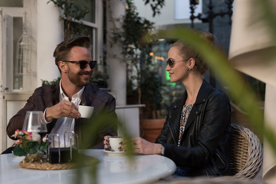 Smiling stylish couple in cafe