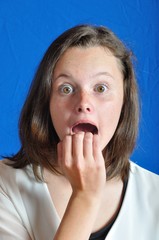 Scared teen on blue background