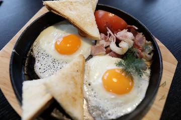 Bacon and eggs in skillet