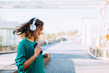 Teenager dancing listening music on the street.