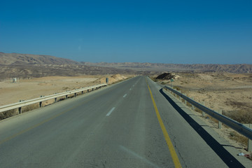 Fototapeta na wymiar Wide view of desert road through the Isreal southwest.