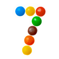 Number 7 seven of sweet colored candies, alphabet isolated on white background
