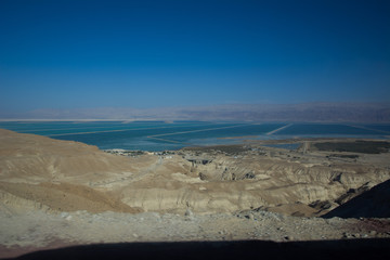 Curvy road with a view on Dead Sea at the end of a Summer day in Negev Desert