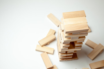 Tower of wooden blocks on gray background. Board game for the whole family or party. Concept of building business or building team. Copy space for text