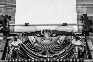 Vintage typewriter, old paper, black and white closeup photo. Mock up for text design