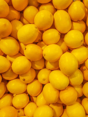 Ripe yellow lemons, background, texture