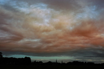 Silhoutte of a village under a very moody sky