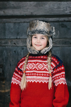 Outdoor Winter Portrait of Cute Norwegian Girl in Traditional Kn