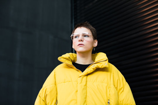 Portrait of woman with short hair and yellow parka