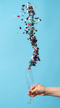 Confetti coming out of champagne glass