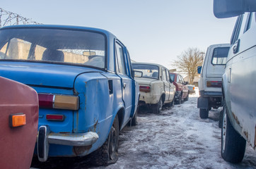 old, abandoned cars in winter